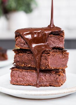 plate of delicious brownies with chocolate sauce poured over them