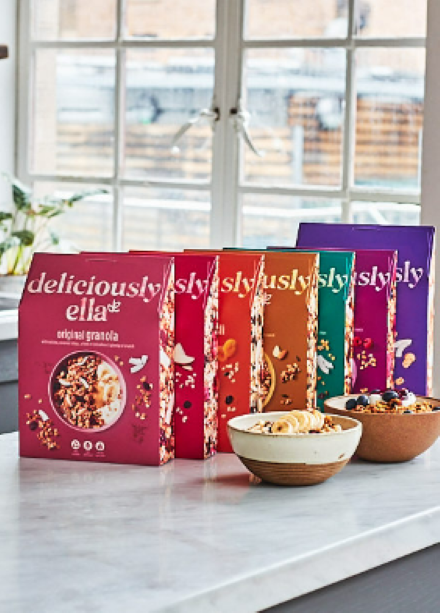 selection of deliciously ella granola boxes with 2 bowls of granola
